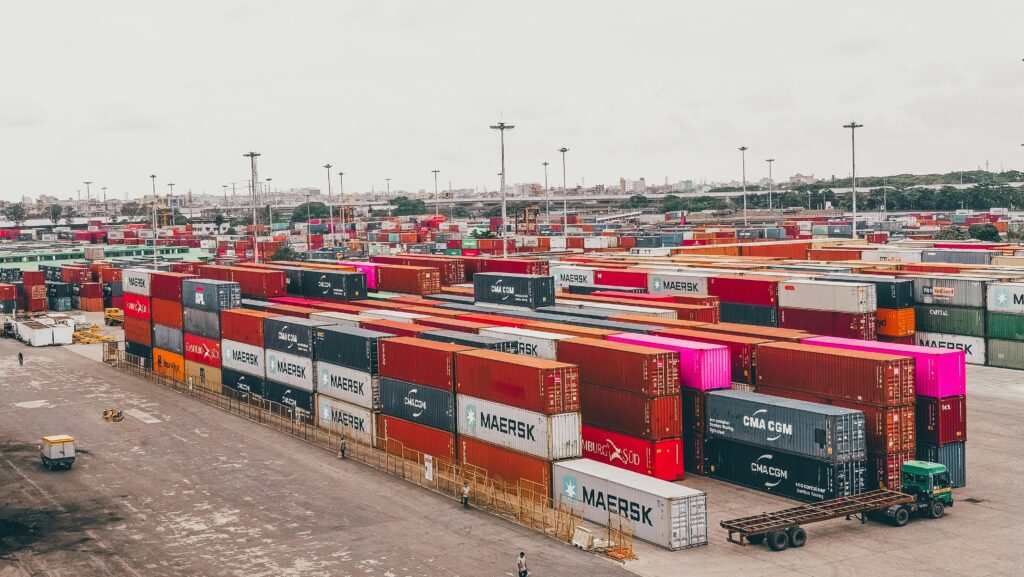 Colorful shipping containers stacked at a bustling port showcasing global trade.